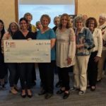 100Women reps awarding CASA the total donation of $16,550.00.