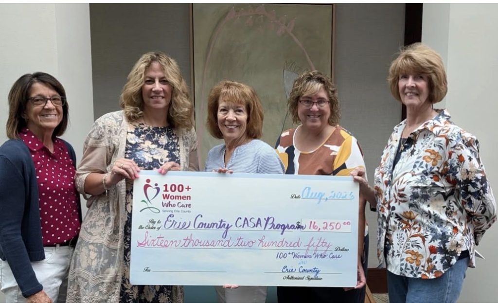 A group of members join Terry after the July meeting where members chose CASA to receive the groups July donation.