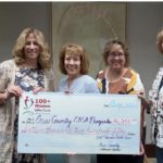 A group of members join Terry after the July meeting where members chose CASA to receive the groups July donation.