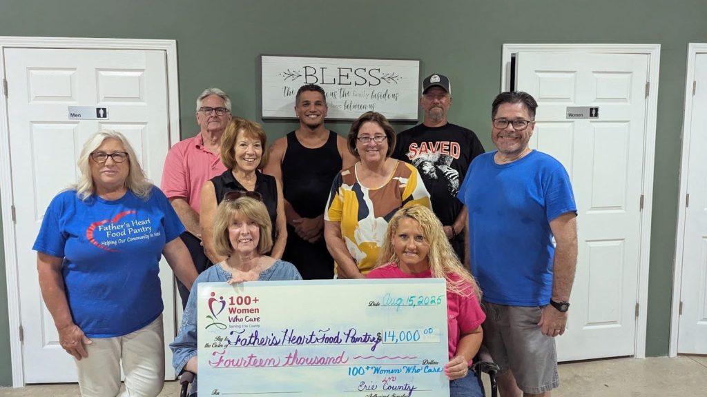 Members from Fathers Heart Food Pantry accept the $14,000.00 from members of 100 Women Who Care.