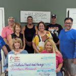 Members from Fathers Heart Food Pantry accept the $14,000.00 from members of 100 Women Who Care.