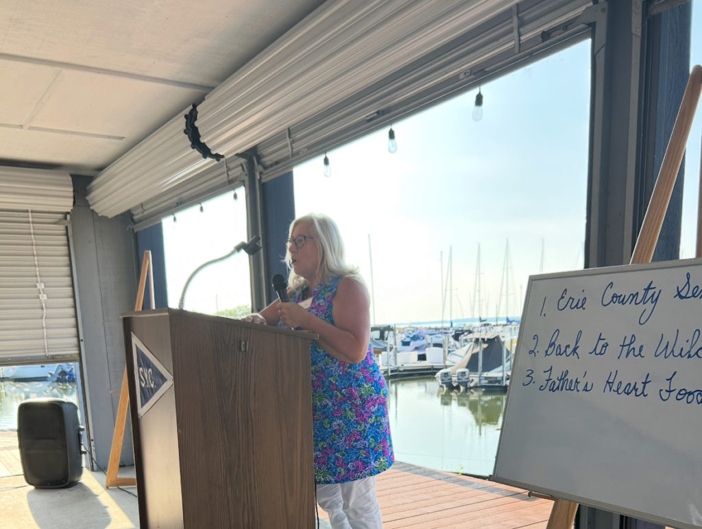 Vicki Fitzpatrick passionately presenting Fathers Heart Food Pantry at 100 WWC July 2025 meeting.