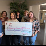 Representatives of 100 Women present checks to Bayshore Counseling Services Board members