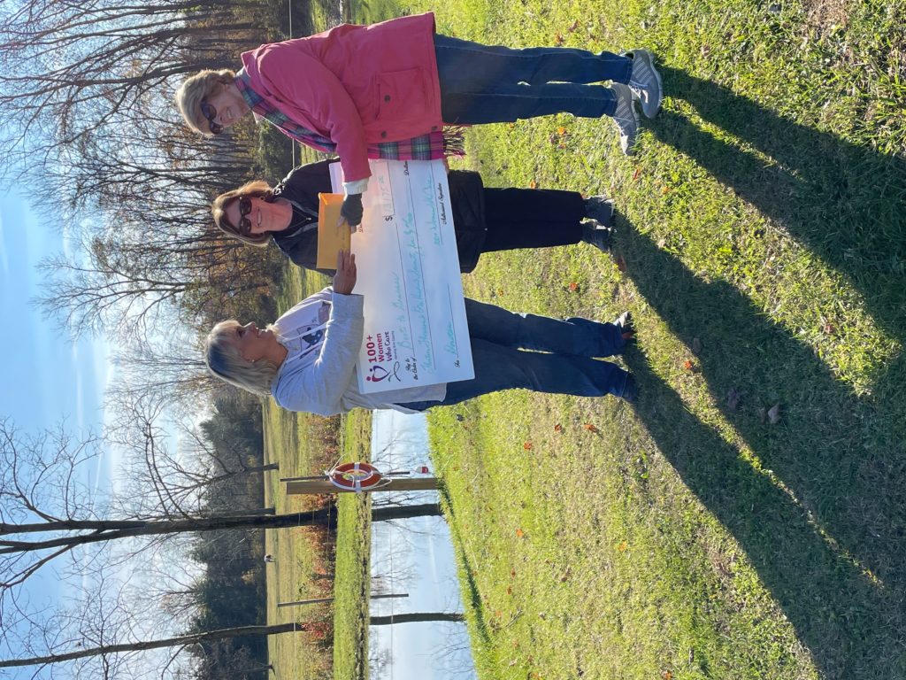 Laura accepting a check at the farm.