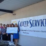 Cancer Services receiving a check from 100 Women